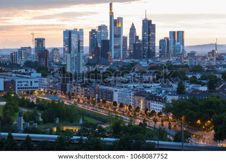 Panorama of city Frankfurt am Main - business capital of Germany at the twilight light . Top view of the business center: illuminated skyscrapers, buildings and city streets in the night lights.
