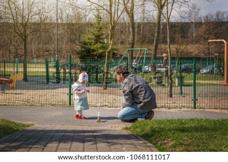 Little baby girl walking with her dad.