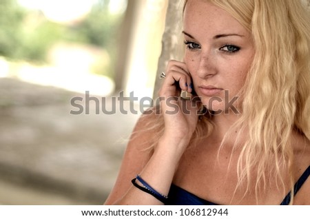 Young beautiful blond woman with cellphone