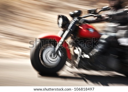 Abstract slow motion, biker riding motorbike, driver racing on the big red bike, side view, blur movement, summer road trip, speed concept Royalty-Free Stock Photo #106818497