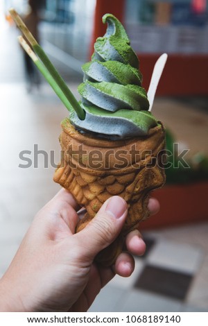 Sesame and Green Tea ice cream swirl at japan town in San Francisco in a taiyaki cone eaten outside deliciously looking