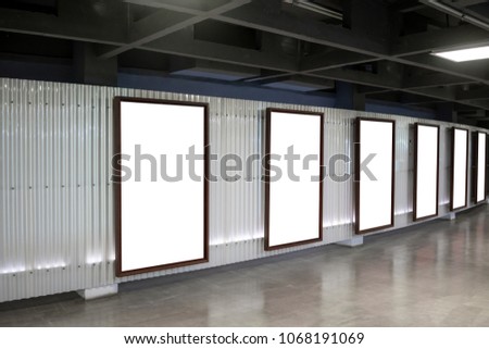 Six movie poster frames along the walkway in modern interior design for movie theater or art gallery
