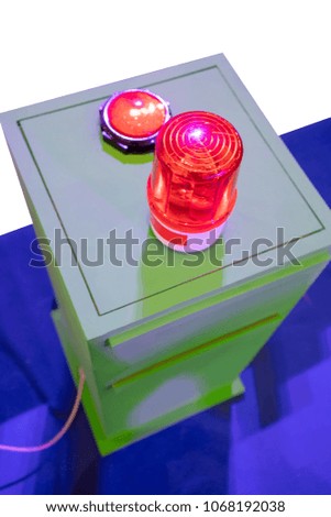 Red siren on metal cabinet. Warning light for safety on work area.