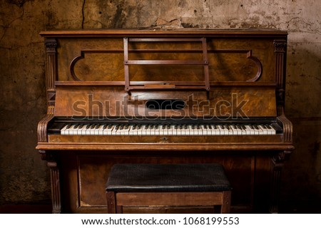 Old wooden piano keys on wooden musical instrument in front view Royalty-Free Stock Photo #1068199553