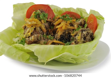 Stewed in sour cream rabbit meat in cabbage leaf
