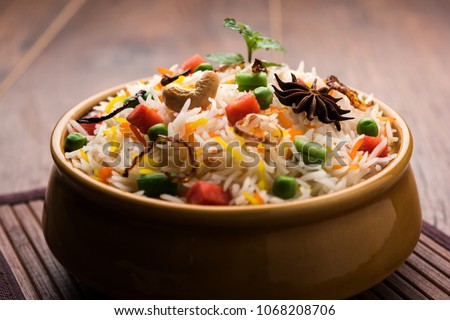 Indian Vegetable Pulav or Biryani made using Basmati Rice, served in a ceramic bowl. selective focus
 Royalty-Free Stock Photo #1068208706