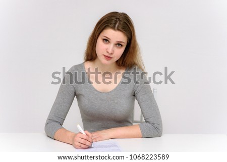 beautiful girl is sitting at the table