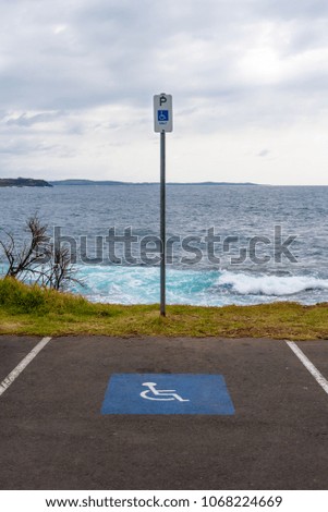 Special parking place spot and marking sign for disabled people near seaside in Australia