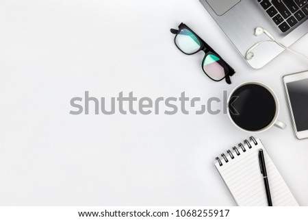 White office desk table with computer,coffee cup,and glasses. Top view with copy space
