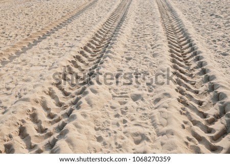 Traces from tires on sand. Print of machine tires.