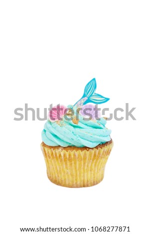 Mermaid cupcake. Buttercream muffin with mermaid and seashells decoration on top. Fairy tales inspiration. Cupcake isolated on white background
