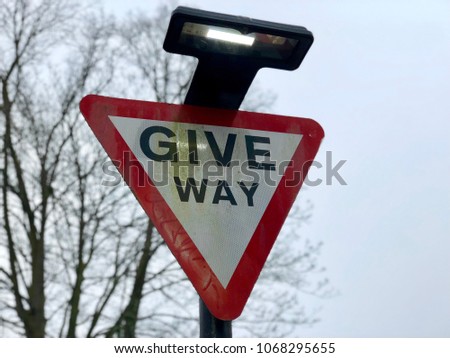 British road give way illuminated red triangle sign