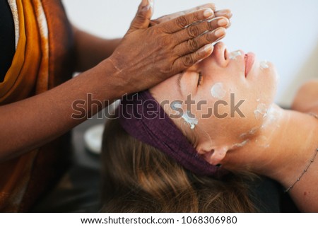 The girl doing the facial massage . The cream on the face. Ayurvedic treatment. Spa treatments in Asia. Ayurveda salon
 Royalty-Free Stock Photo #1068306980