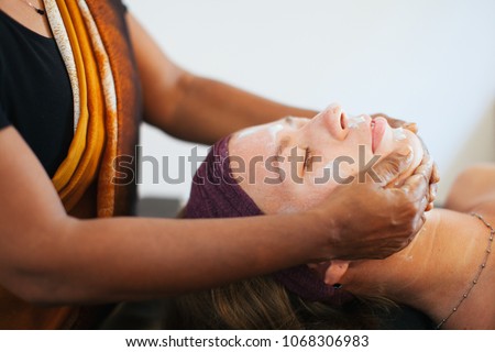 The girl doing the facial massage . The cream on the face. Ayurvedic treatment. Spa treatments in Asia. Ayurveda salon
 Royalty-Free Stock Photo #1068306983