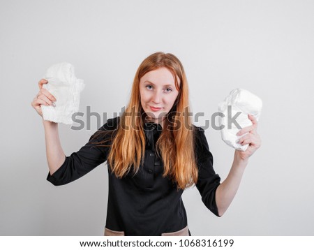 Young woman with a diaper over a white background