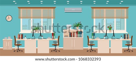 Office room interior including four workspaces with cityscape outside window.