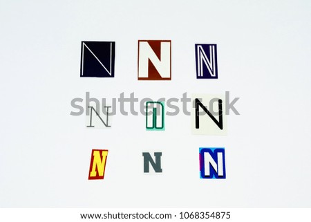 Set of collection colorful newspaper cut out letters as ornaments or design elements. Isolated on white background. Letter N. 