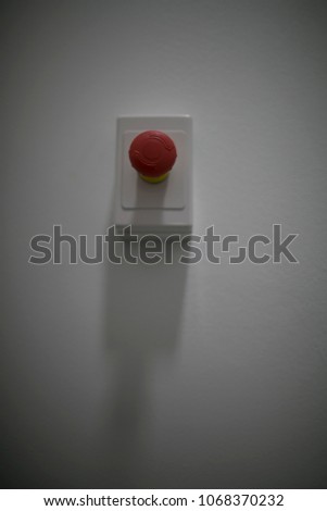 Emergency red button sign on the wall with white background on construction site in Sydney city, Australia  