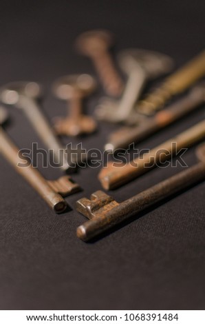 Old vintage keys on black background. Several types of old retro keys. Composition of different keys. 