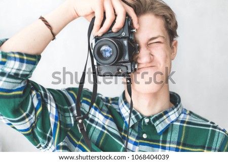 Hipster taking pictures on an old camera