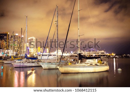 Beautiful night view of San Diego California with boats, lit buildings and water