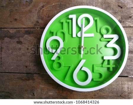 Clock on wooden background. The time is 12:00 am or pm. Twelve o'clock Royalty-Free Stock Photo #1068414326
