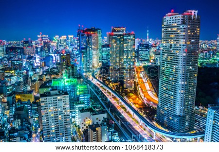 Asia business concept for real estate and corporate construction - panoramic urban city skyline aerial view under twilight sky and neon night with highway junction in hamamatsucho, tokyo, Japan