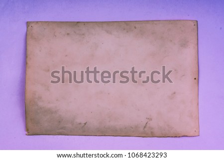 Vintage and antique art concept. Front view of blank old aged dirty photo frame texture with stains and scratches on abstract blurred background. Detailed closeup studio shot.