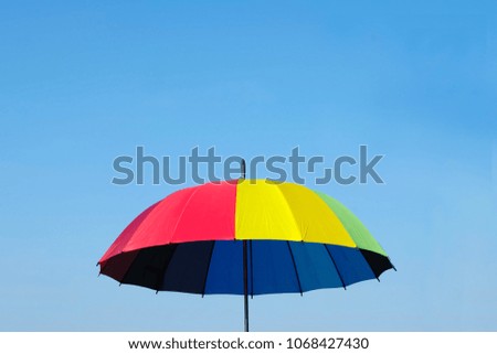Rainbow umbrella on the blue sky. concept:summer ,UV radiation, protected sunlight, Sunscreen ,safety
