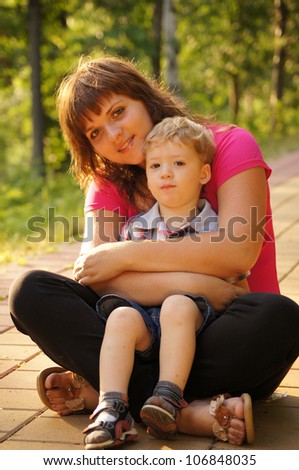 The little boy with mum on walk