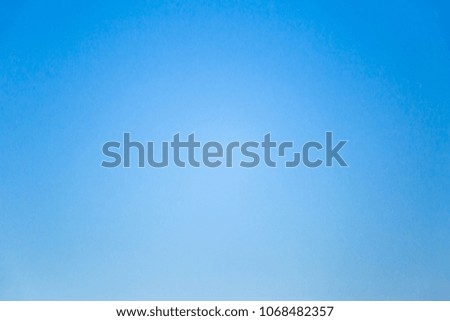 Real image photo of gradient blue sky background with vignette border.