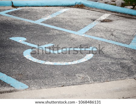 Selective focus image of old handicapped parking sign on a parking lot / With Copy Space
