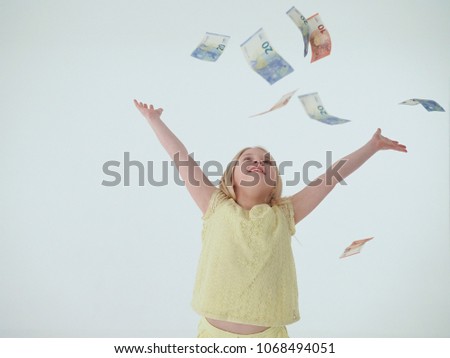 Girl throws 10 and 20 Euro notes in the air.