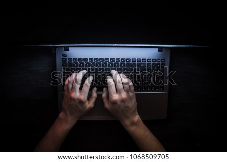 Russian hacker hacking the server in the dark Royalty-Free Stock Photo #1068509705