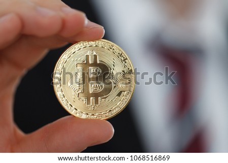 Businessman showing Gold Bitcoin