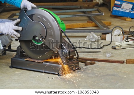 Construction working with cutting grinder