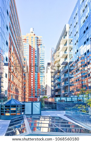 Modern glass skyscrapers apartment residential buildings in New York City NYC by high line highline in Chelsea West Side by Hudson Yards