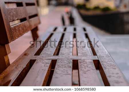 A wet wooden bench. (closeup)