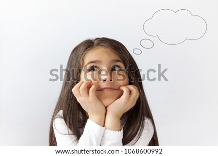 Cute thoughtful child girl with an empty thought bubble. Dreaming people
