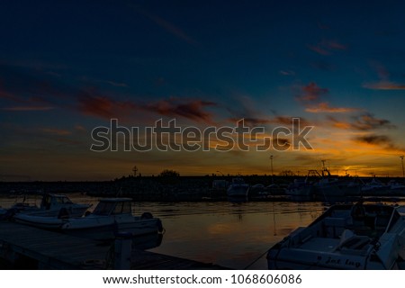 Gioia Tauro , Italy - APRIL 8, 2011: 
marine port, sunset with strong and colored lights of Reggio Calabria