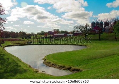 Pond in middle of large farm.