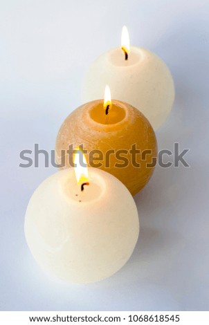 Three lighted candles, selective focus.
