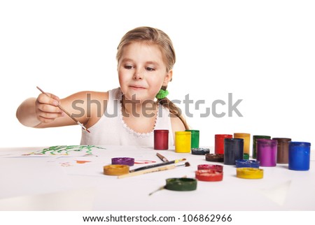 small beautiful girl paints on paper over white background