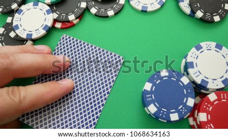 Poker Player Makes a Bet On The Table With Poker Chips. Cards On Table In Casino