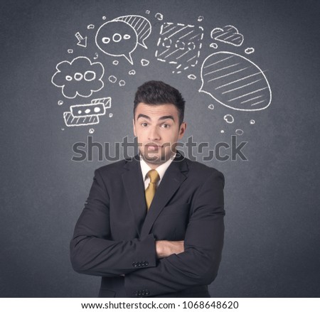 Young businessman with drawn speech bubbles over his head