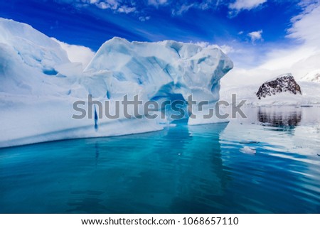 Antarctica iceberg floats in calm water