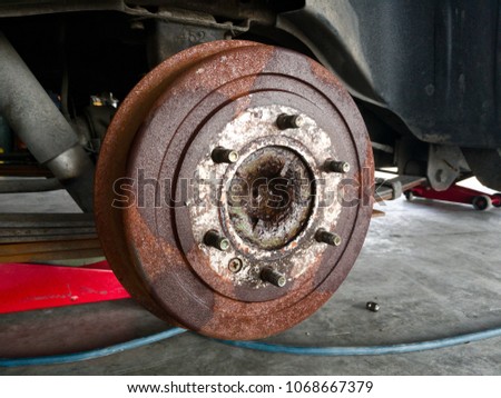 Close up car wheel part background, maintenance wheel detail, repair car part in garage, lifting car with equipment
