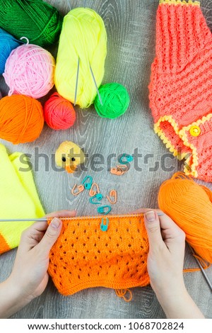 girl knits sock knitting needles on gray background