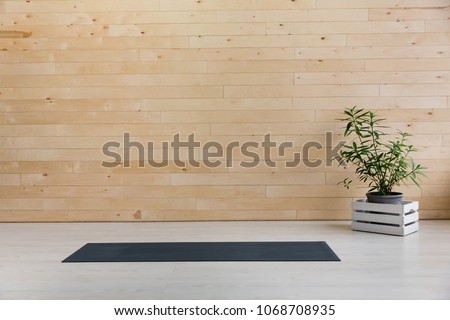 Gym with yoga mat on the floor Royalty-Free Stock Photo #1068708935