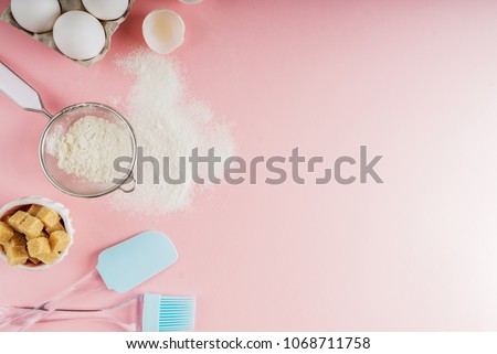 Frame of food ingredients for baking on a gently pink pastel background. Cooking flat lay with copy space. Top view. Baking concept. Mockup. Royalty-Free Stock Photo #1068711758